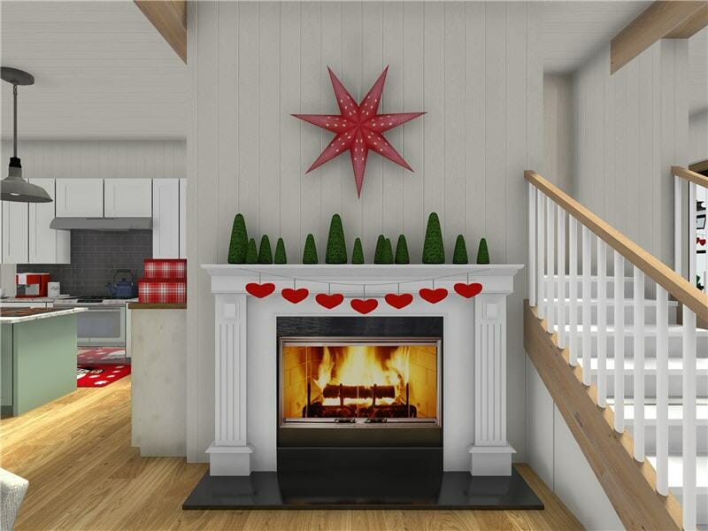 3D-rendered image of a festive living space featuring a white fireplace with a roaring fire. The mantel is decorated with small green cone-shaped trees and a red heart garland. Above the mantel hangs a large red star decoration. To the left, a glimpse of the kitchen reveals holiday touches, including a red and white rug and red appliances.
