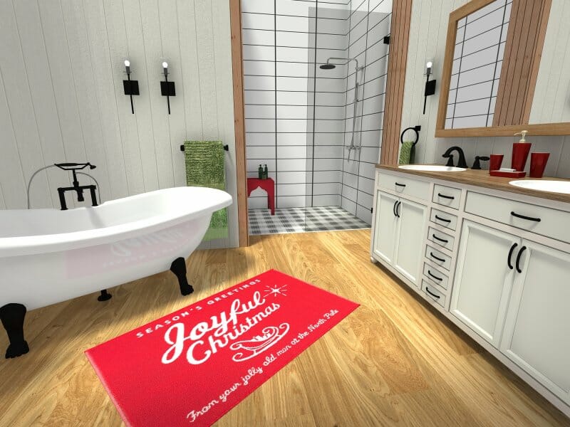 3D-rendered holiday-themed bathroom featuring a freestanding clawfoot tub, a walk-in shower with white subway tile, and a white double-sink vanity with black fixtures. The space includes wood-look flooring, a red Christmas-themed bath mat, and red accents such as cups and soap dispensers.