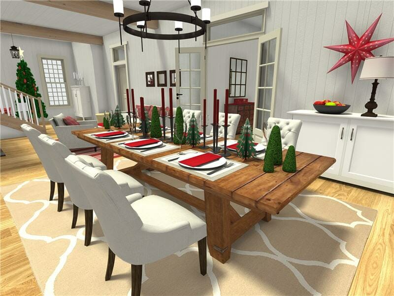 3D-rendered image of a holiday-themed dining room with a large rustic wooden table set for a festive meal. The table is decorated with red napkins, black candle holders with red candles, and small green Christmas tree figurines. White upholstered chairs surround the table, which sits on a beige patterned rug.