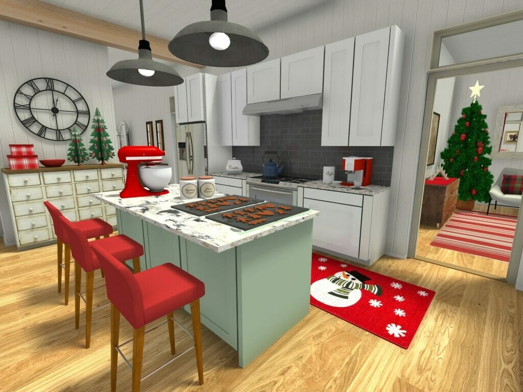 3D-rendered image of a festive holiday kitchen decorated in red and green. A mint green island with a marble countertop is topped with gingerbread cookies, a red stand mixer, and baking supplies. Red barstools line the island, and a red snowman-themed rug adds a cheerful touch near the stove. In the background, a large wall clock, mini Christmas trees, and stacked gift boxes sit on a sideboard.