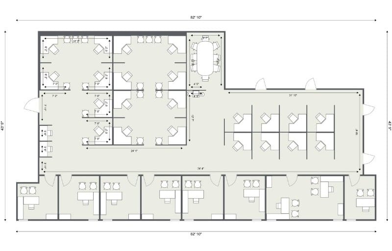 2D office floor plan with labeled measurements showing a large open workspace, several cubicle zones, private offices, and a conference room. The layout includes individual desks, meeting areas, and workstations arranged for efficient flow within the rectangular floor plan.