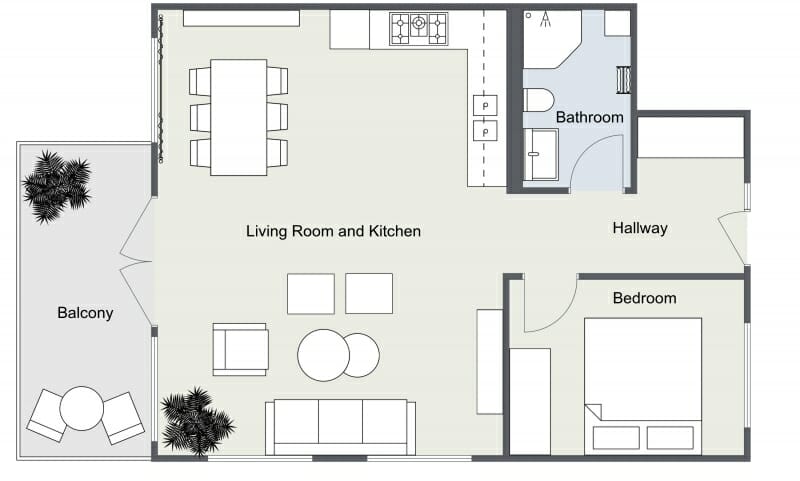 2D floor plan of a one-bedroom apartment showing a combined living room and kitchen area, a separate bedroom, a bathroom, a hallway, and a balcony with outdoor seating and plants.