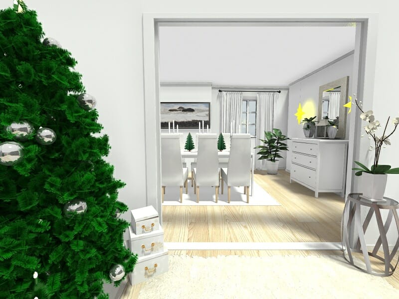 3D-rendered image of a bright, modern dining room decorated for the holidays. The view is from an adjacent room with a Christmas tree adorned with silver ornaments and stacked gift boxes. The dining area features a white table with tall white chairs, small tabletop Christmas trees, and a centerpiece of candles. The room is accented with greenery, white curtains, and minimalist decor, creating a festive and elegant atmosphere.