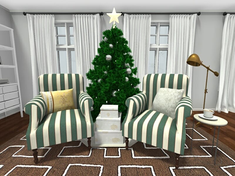 3D-rendered image of a holiday-themed sitting area with a Christmas tree in the center. The tree is decorated with silver ornaments and topped with a gold star. Two green and white striped armchairs with decorative pillows face each other on either side of the tree. Stacked white gift boxes sit in front of the tree. A small round table with a teacup and a gold floor lamp are placed next to the right chair. The room features white curtains, dark wood flooring, and a brown patterned rug.