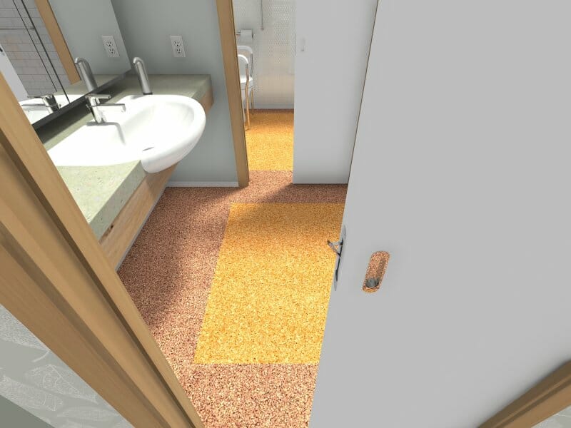 3D rendered view of an accessible bathroom designed for universal use. Features include a wall-mounted sink with clearance underneath for wheelchair access, a wide sliding door for easy entry, and color-contrasted flooring zones for visual guidance and safety. A grab bar and accessible toilet are visible in the background.